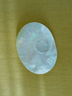 mother of pearl dish being used as a jewelry tray