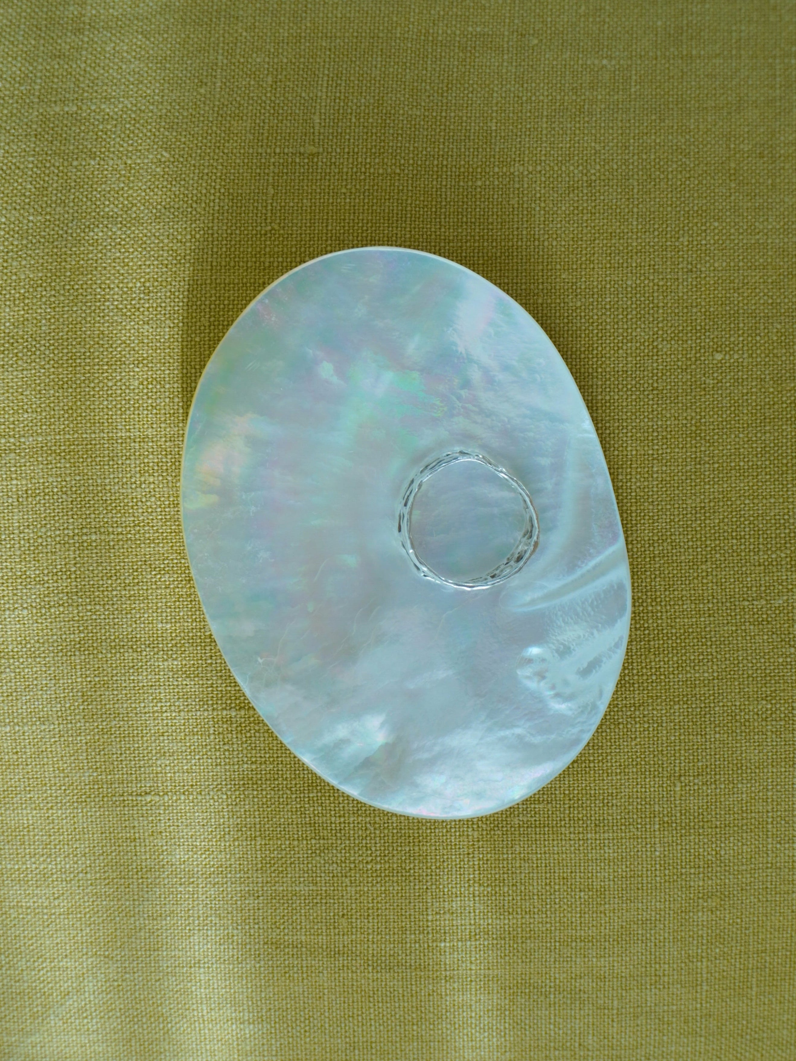 mother of pearl dish being used as a jewelry tray