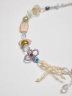 Necklace with colorful beads and a butterfly charm on a white background