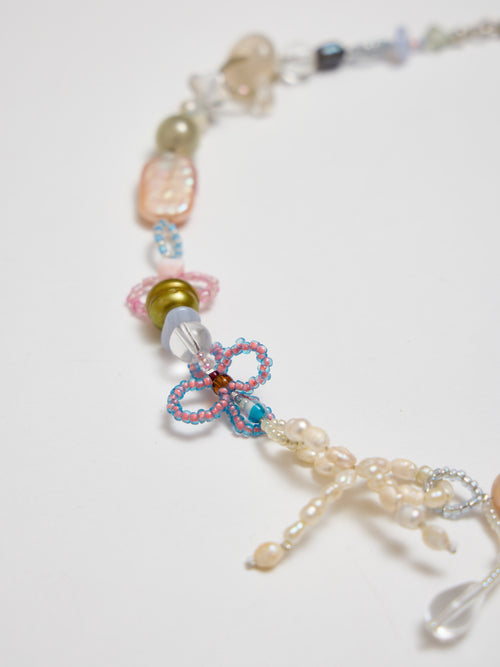 Necklace with colorful beads and a butterfly charm on a white background