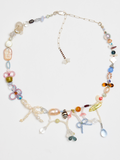 Colorful beaded necklace on a light gray background