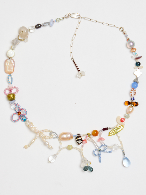 Colorful beaded necklace on a light gray background