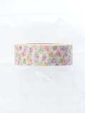 A roll of washi tape with a delicate pastel floral pattern on a white background, photographed against a clean white backdrop.