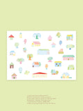 A print of colorful illustrated houses, trees and flowers depicting a whimsical village